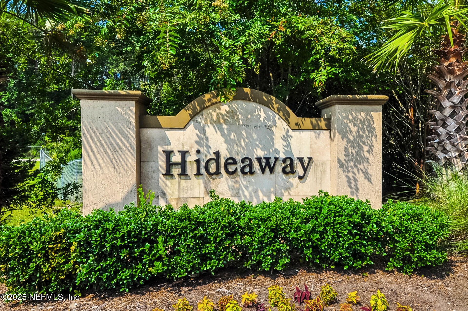 86192 Fortune Drive Yulee, FL 32097 - Photo 2 of 33 a sign that is sitting in front of flowers