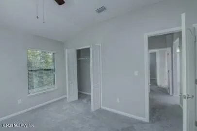 an empty room with a empty space and windows