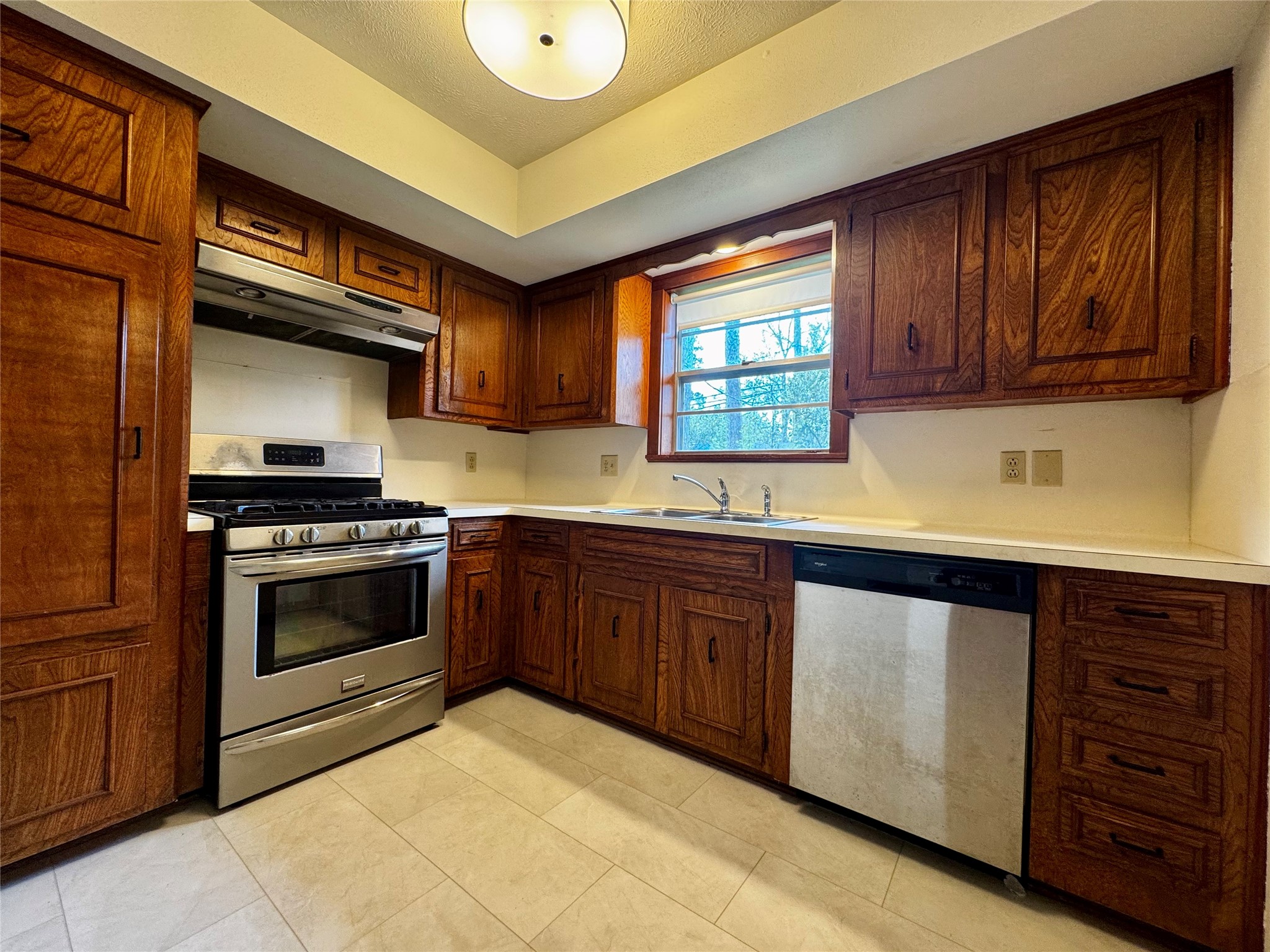 24231 Shellbrook Drive Houston, TX 77336 - Photo 9 of 42 a kitchen with granite countertop a stove cabinets and microwave