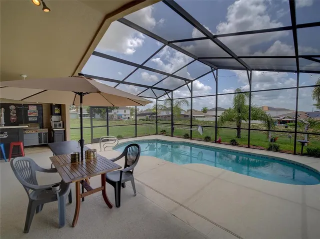 a dining room with furniture and floor to ceiling window