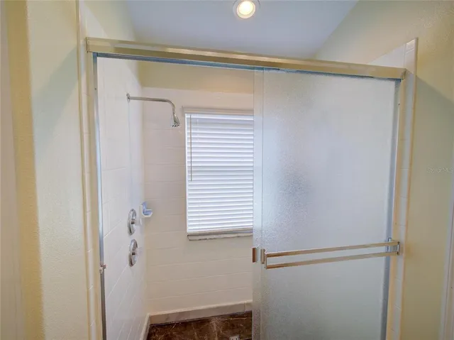 a en suite bathroom with a granite countertop sink a mirror and a toilet