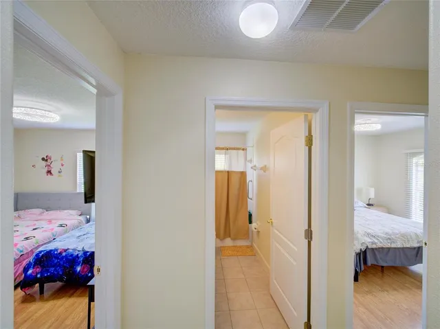 a bedroom with a bed and a painting on the wall