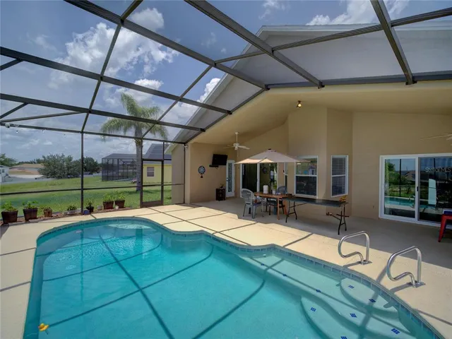 a dining room with furniture and a floor to ceiling window