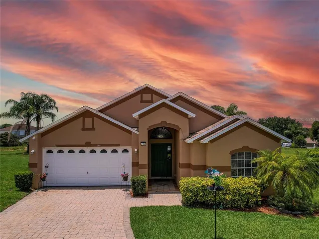 an outdoor view of house with swimming pool and green space