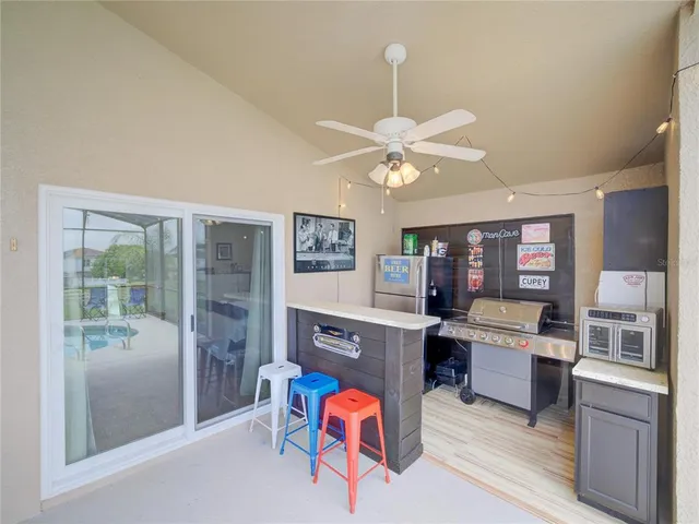 a living room with furniture a fireplace and a chandelier