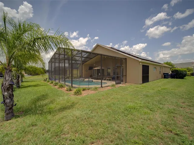 a view of a house with backyard and sitting area