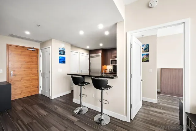 a view of a hallway with wooden floor and furniture