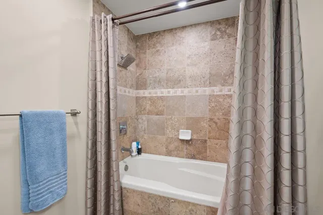 a bathroom with a shower and a bath tub