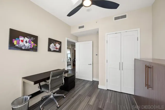 a view of a workspace with wooden floor