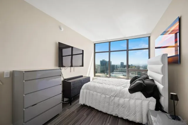a bedroom with a bed and a large window