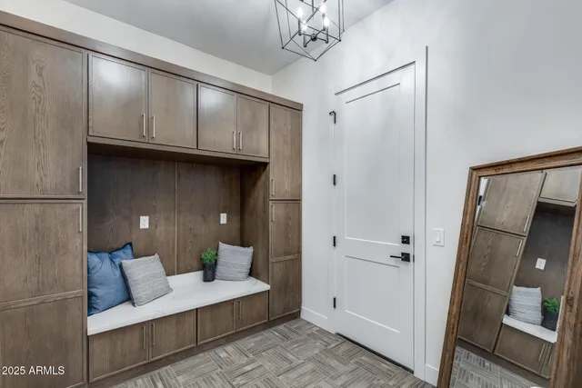 a kitchen with a dining table chairs refrigerator and microwave