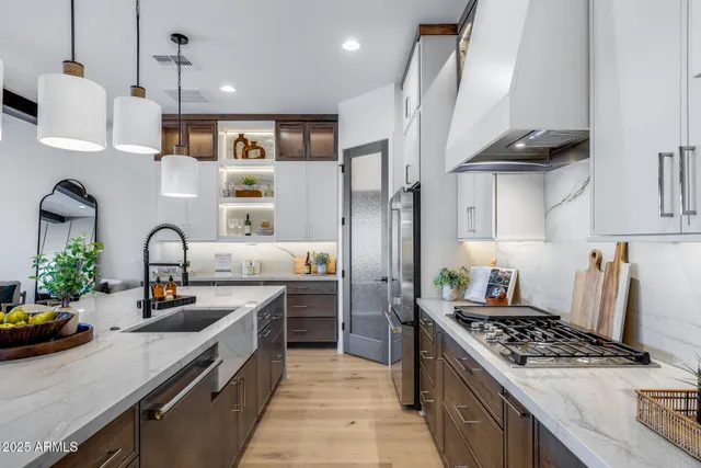 a dining room with stainless steel appliances kitchen island granite countertop a dining table chairs and view living room