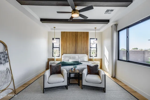 a view of a patio with a table and chairs under an umbrella