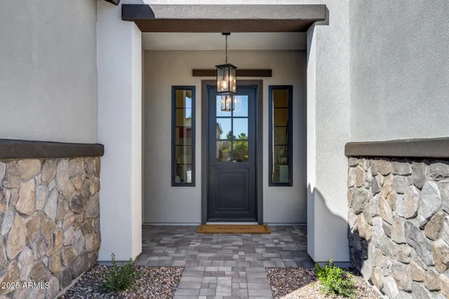 a view of a hallway to a livingroom and a chandelier
