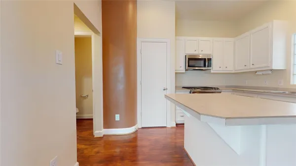 a kitchen with stainless steel appliances a stove microwave and a refrigerator