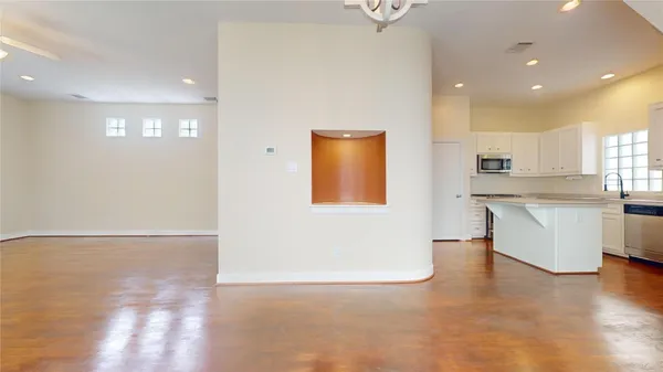 a view of a kitchen with furniture and wooden floor