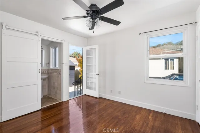 a view of a livingroom with a ceiling fan and wooden floor