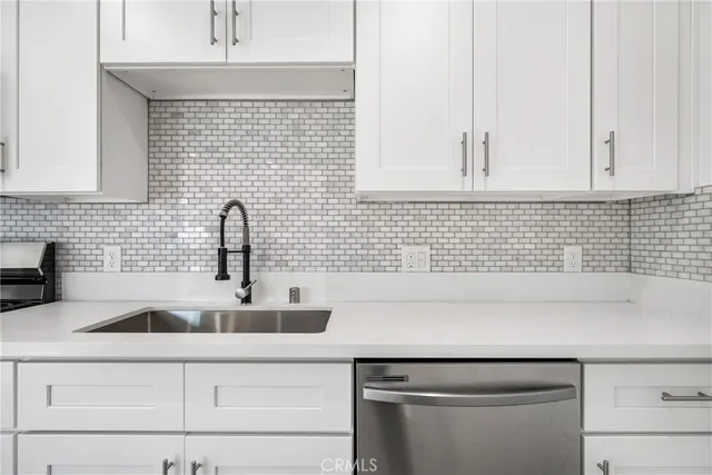 a view of an empty room with wooden floor and closet