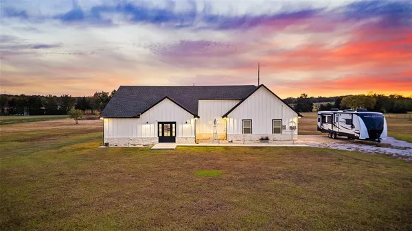 a big house with a big yard and large trees