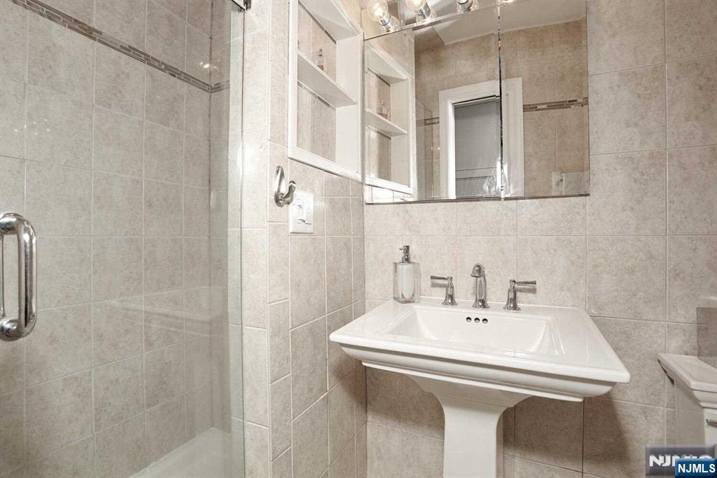 11 Evans Road Cresskill, NJ 07626 - Photo 17 of 31 a bathroom with a sink and a mirror