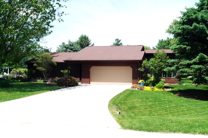 11837 Bend River Road Roscoe, IL 61073 - Photo 1 of 18 a front view of a house with a yard and garage