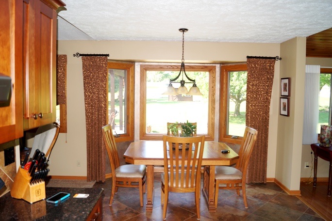 11837 Bend River Road Roscoe, IL 61073 - Photo 11 of 18 a view of a dining room with furniture window and wooden floor