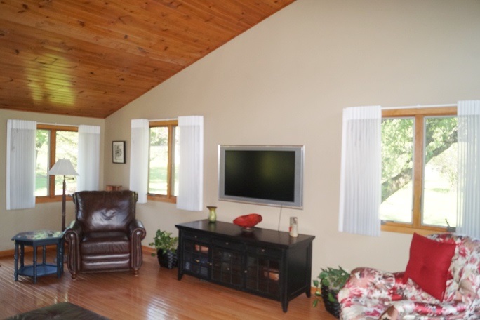 11837 Bend River Road Roscoe, IL 61073 - Photo 14 of 18 a living room with furniture and a flat screen tv