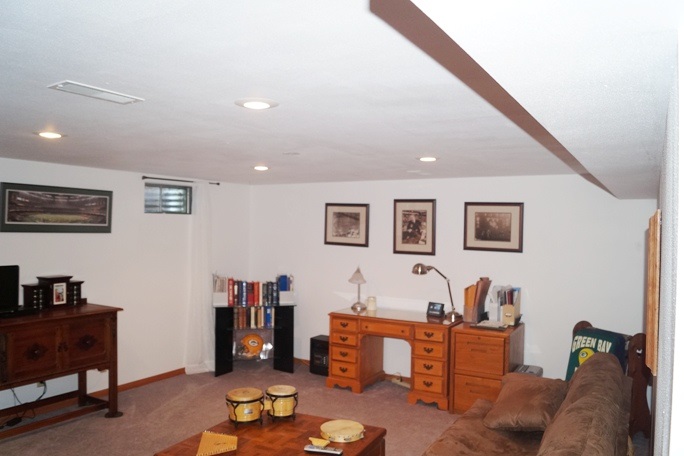 11837 Bend River Road Roscoe, IL 61073 - Photo 17 of 18 a living room with furniture and a flat screen tv