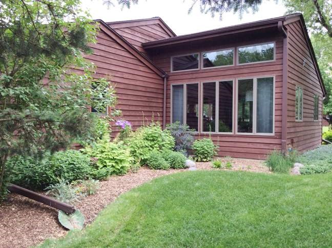 11837 Bend River Road Roscoe, IL 61073 - Photo 2 of 18 a view of a house with potted plants and a table and chair