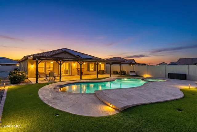 a view of an house with backyard space and balcony