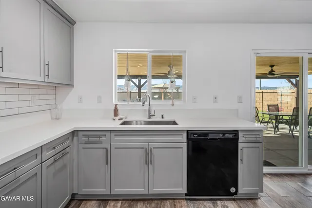 a kitchen with stainless steel appliances granite countertop a sink and cabinets