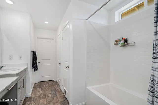 a bathroom with a tub sink and a shower