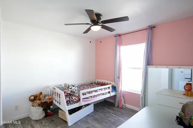 a bedroom with bed and a window