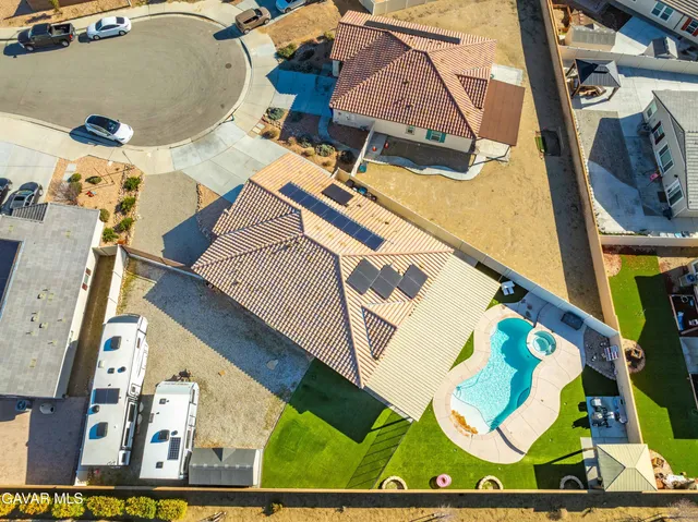 an aerial view of a house with a yard