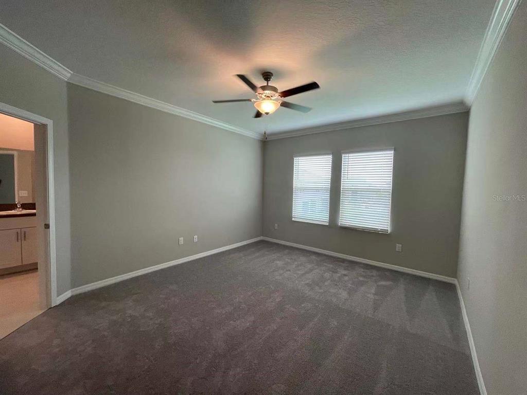 31993 Blue Passing Loop Wesley Chapel, FL 33545 - Photo 14 of 17 an empty room with a window and a ceiling fan