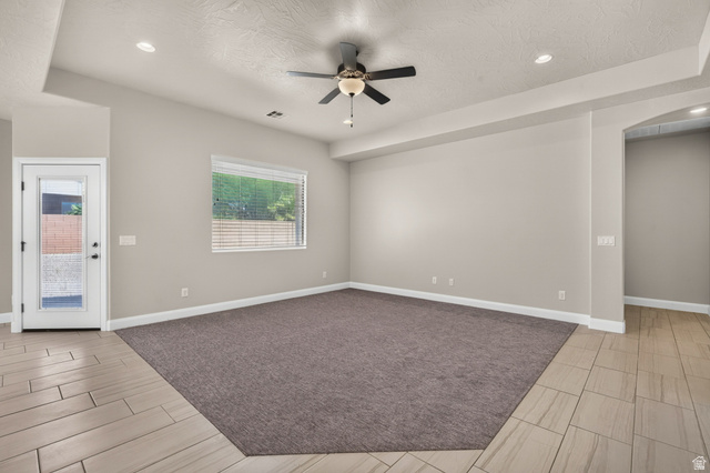 11 East 640 South Ivins, UT 84738 - Photo 11 of 44 Spacious room featuring a ceiling fan with integrated lighting, recessed lighting, and a large window with blinds