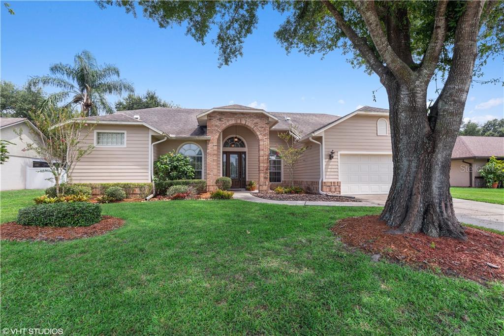 1607 Spring Loop Way Winter Garden, FL 34787 - Photo 1 of 1 Stately oak greets you as you arrive home! Enter through lead glass door and welcome home!