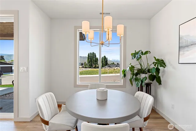 a dining room with furniture and a potted plant
