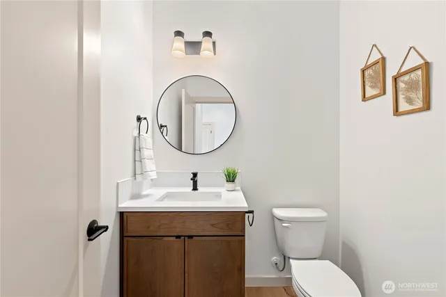 a bathroom with a toilet a sink and a mirror