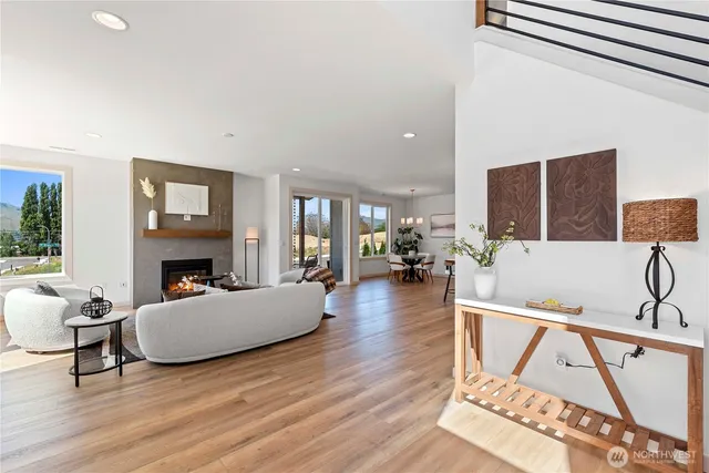 a living room with fireplace furniture and a wooden floor