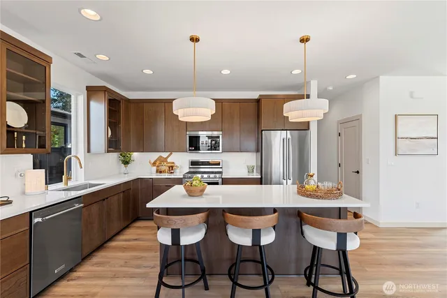 a kitchen with a dining table chairs and sink