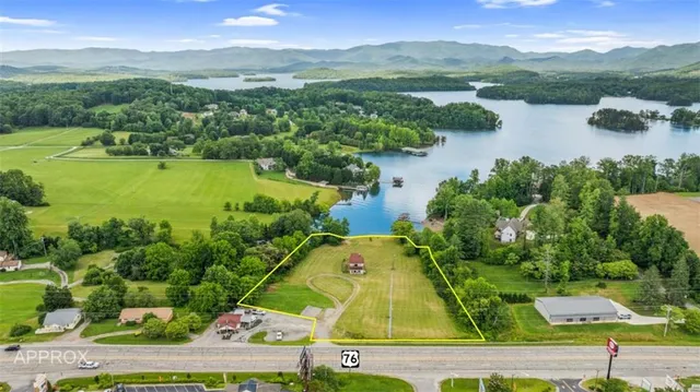 an aerial view of residential houses with outdoor space and river