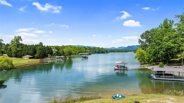 a view of a lake with houses in the back