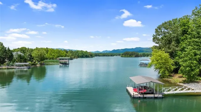 a view of a lake with houses in the back