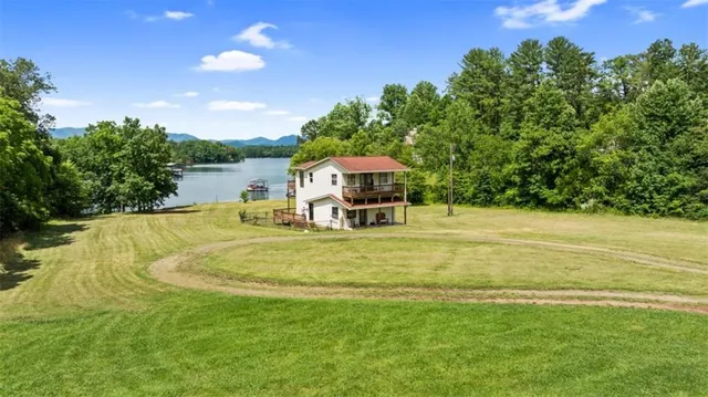 a swimming pool with outdoor seating and yard