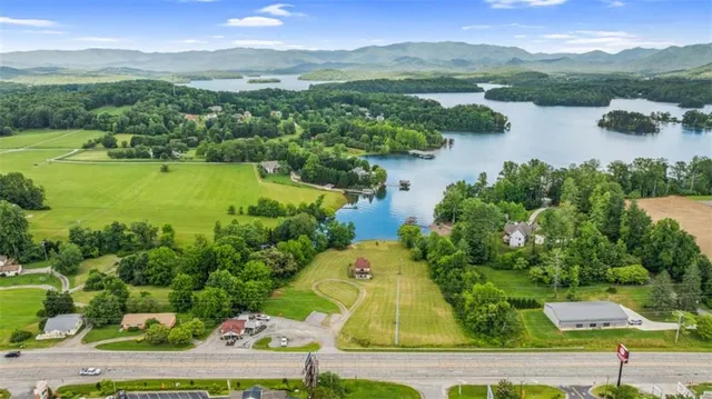 an aerial view of residential houses with outdoor space and river