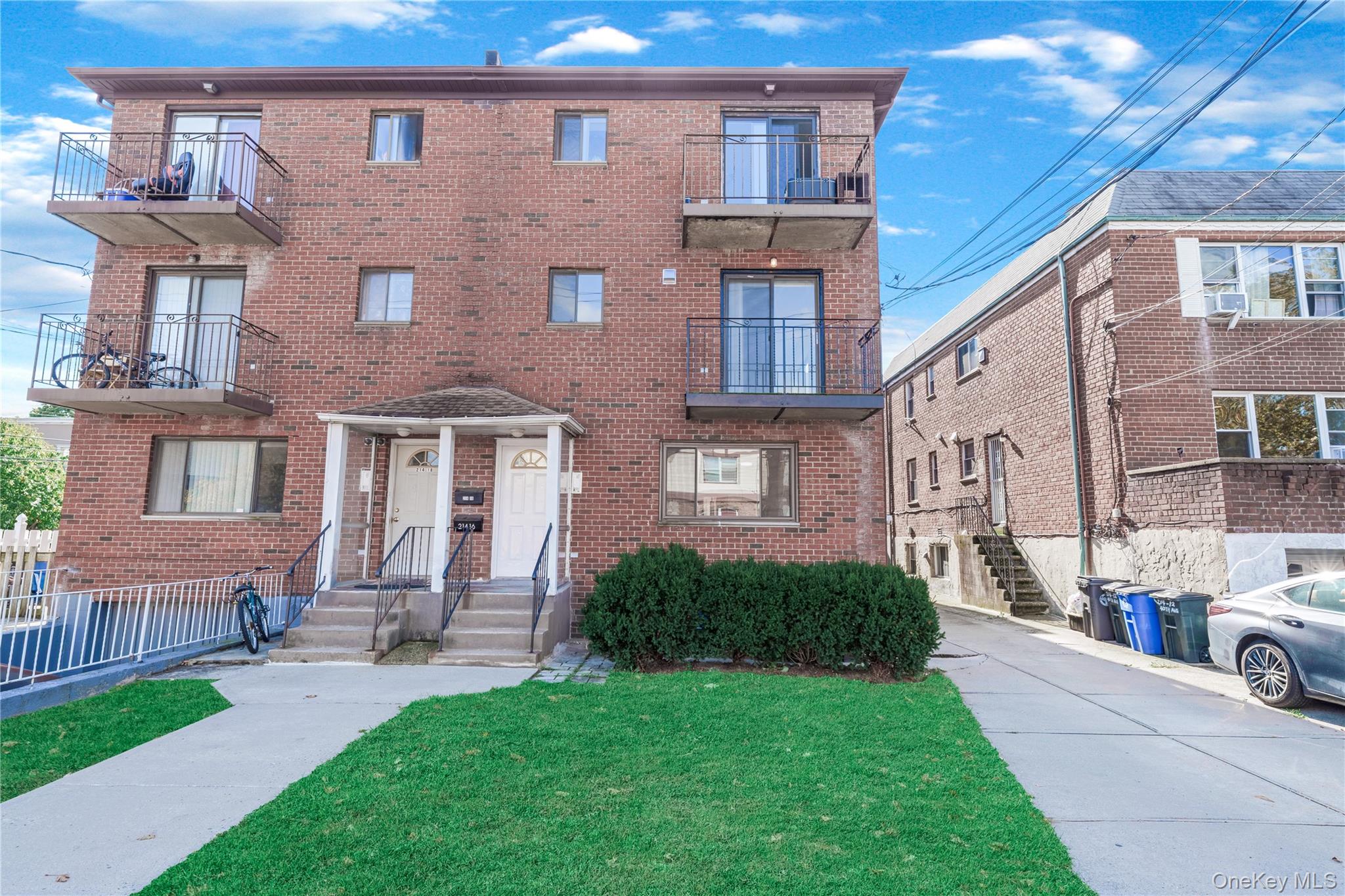 a front view of a house with a garden and plants