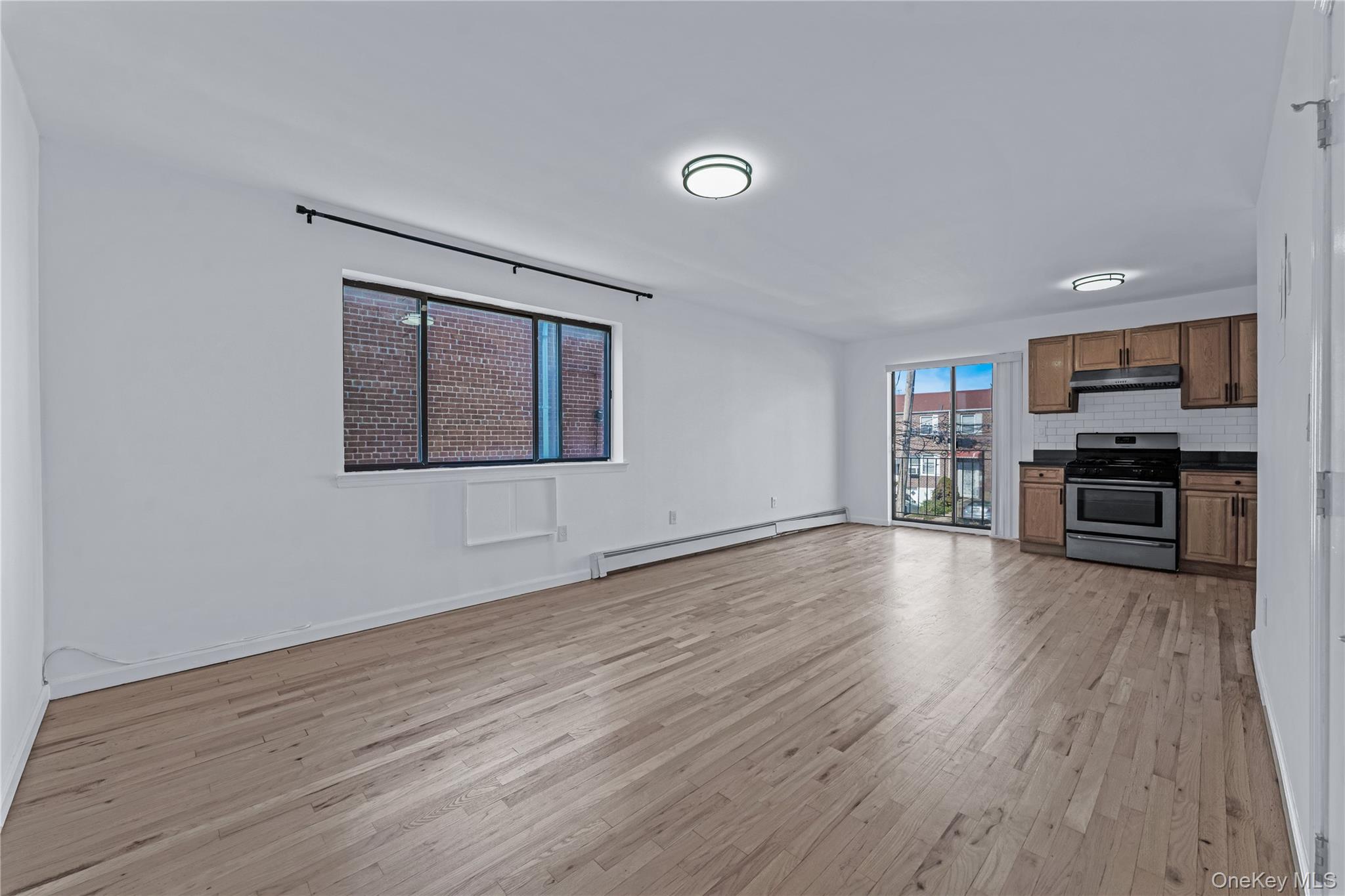 214-16 40th Avenue, Unit 3 Queens, NY 11361 - Photo 2 of 10 a view of empty room with kitchen and window