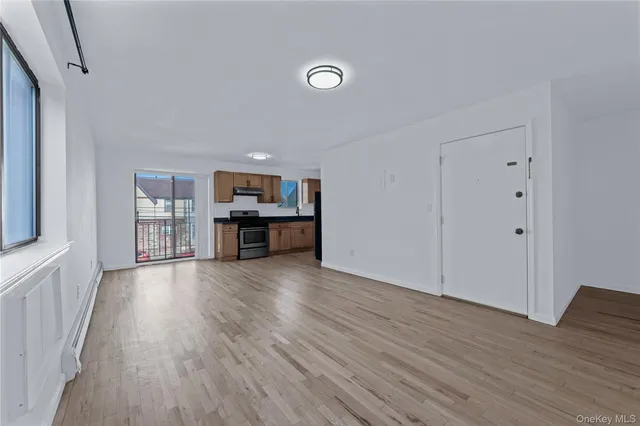 a view of kitchen with livingroom and wooden floor