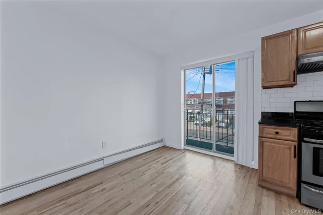 a view of a kitchen with wooden floor and a window